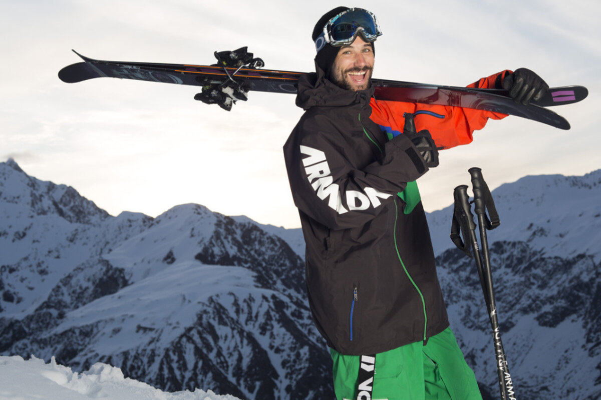 A man wearing a black jacket with the word armada on it