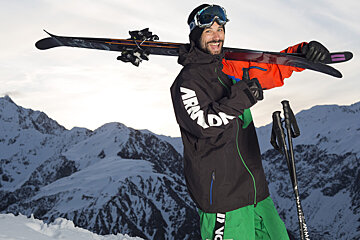 A man wearing a black jacket with the word armada on it