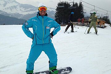 a snowboard instructor with a massive grin on his face