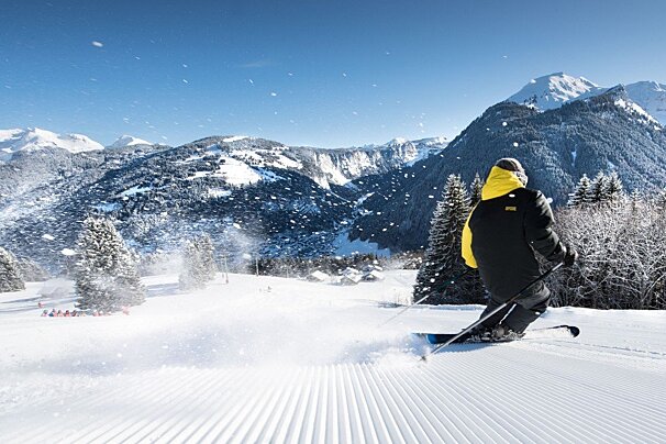 a skier on freshly grromed snow