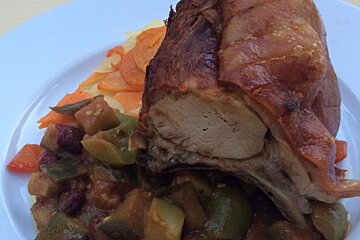 A white plate with meat and vegetables on it