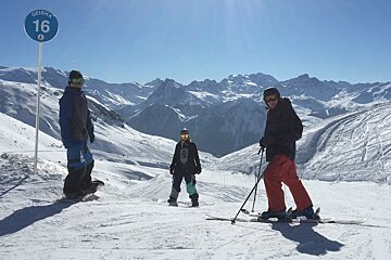 three people near a piste marker