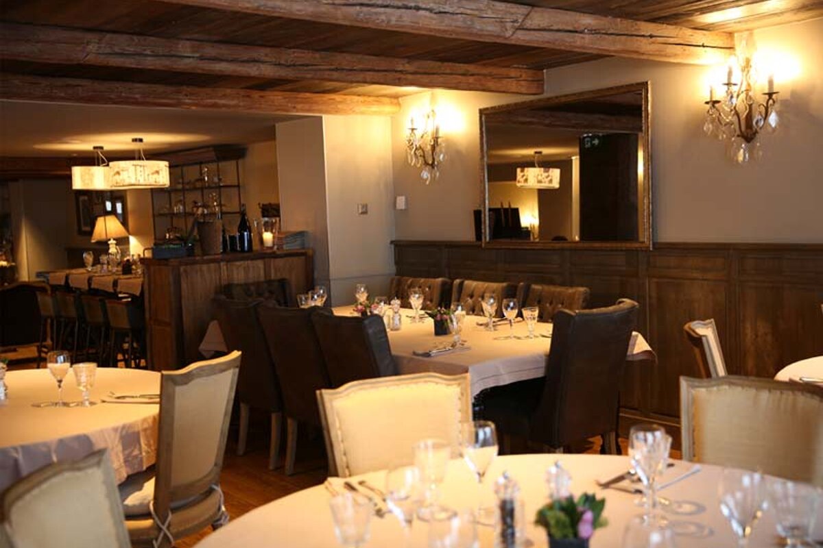 A restaurant with tables and chairs set for a meal