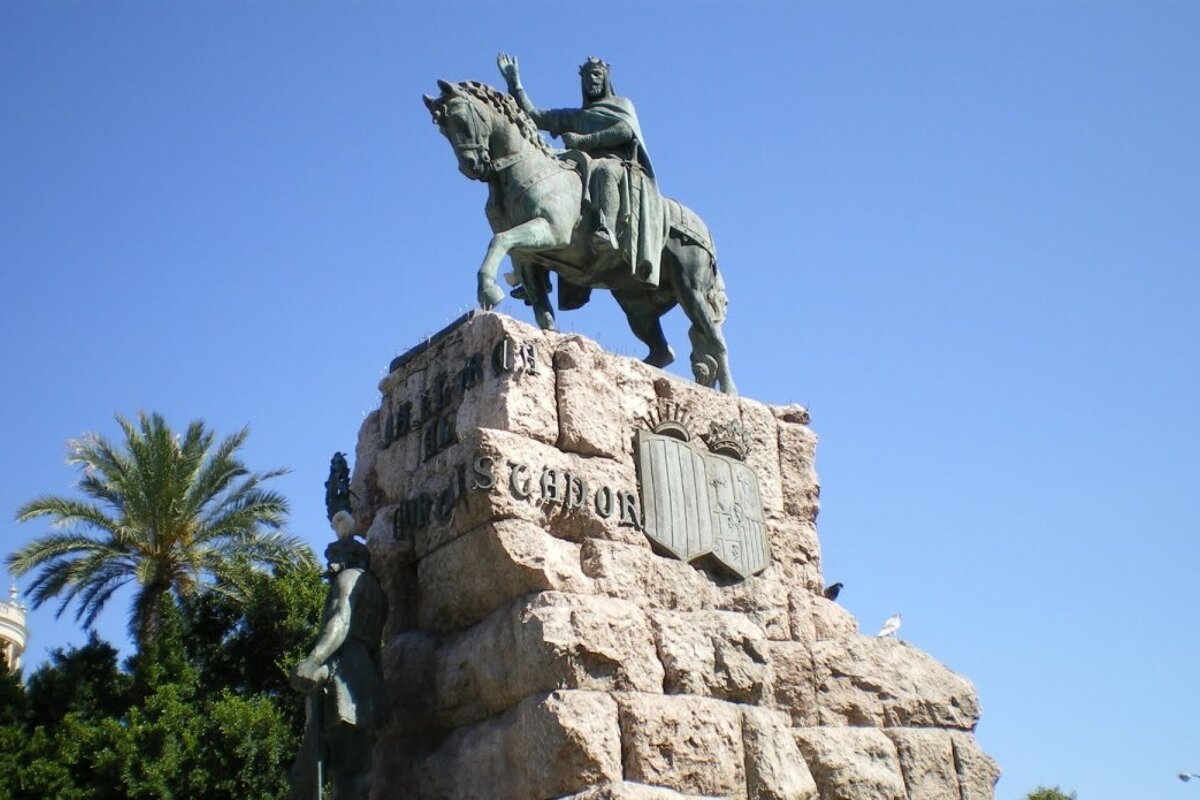 A statue of a man riding a horse with the word sgjor on it