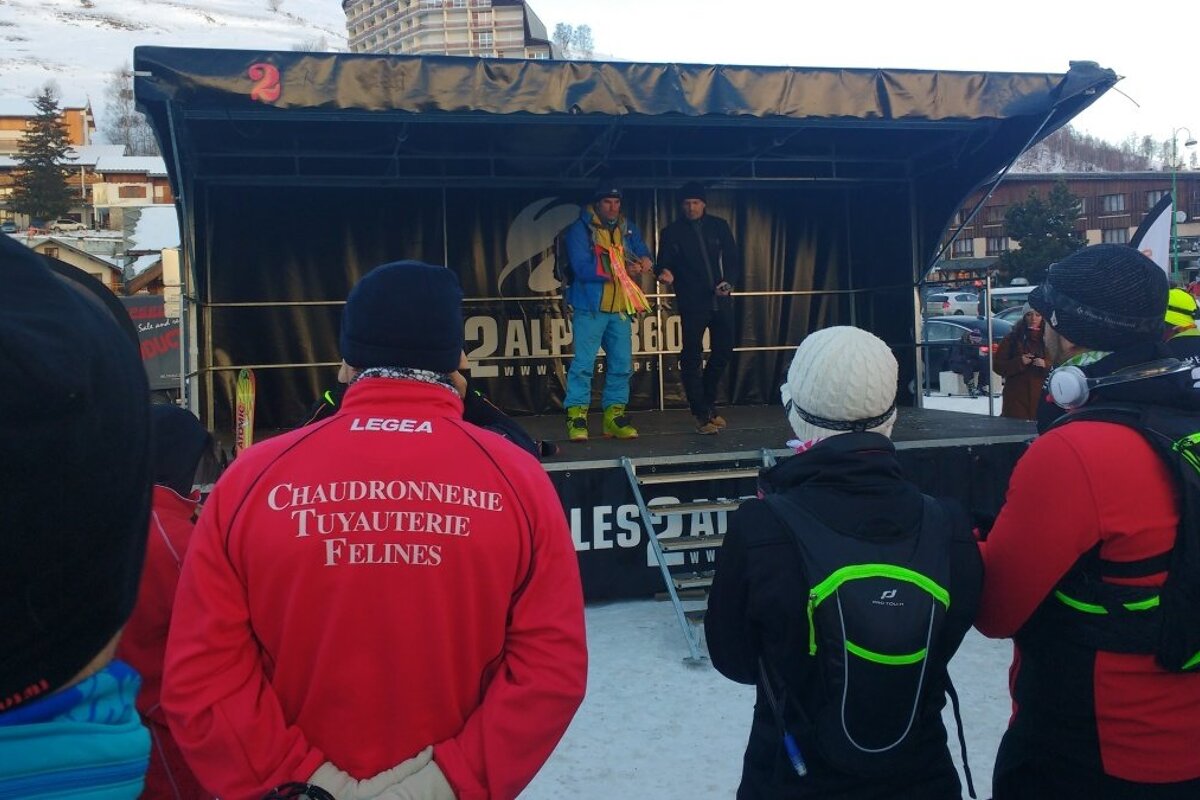 two people on stage talking to runners