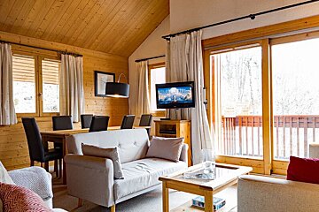 A living room with a couch and a flat screen tv