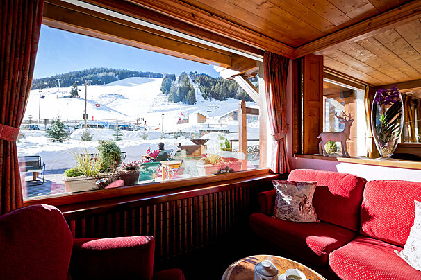 A living room with a view of a snowy mountain