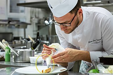 A chef with the name jean-luc renaud on his jacket