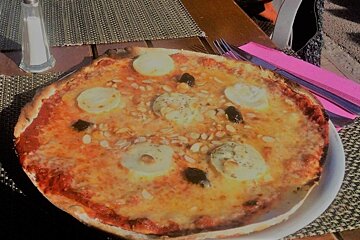a pizza at a restaurant in courchevel