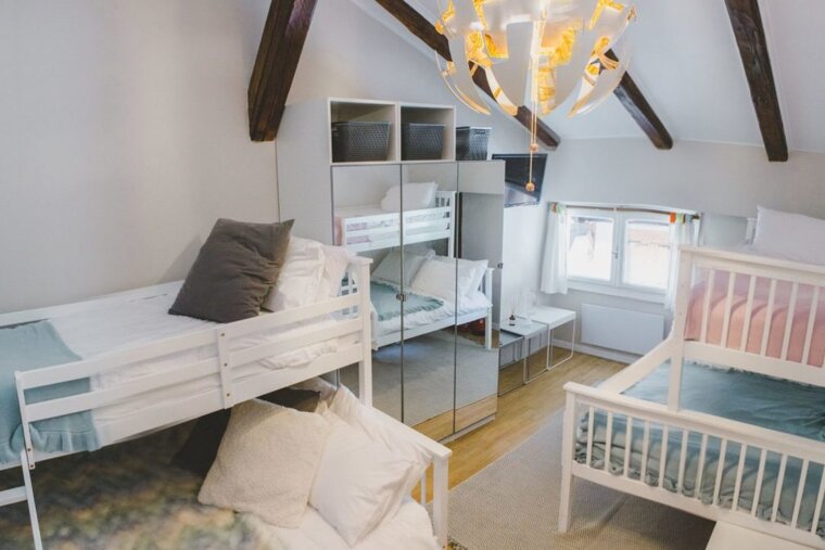 a room with multiple beds for families