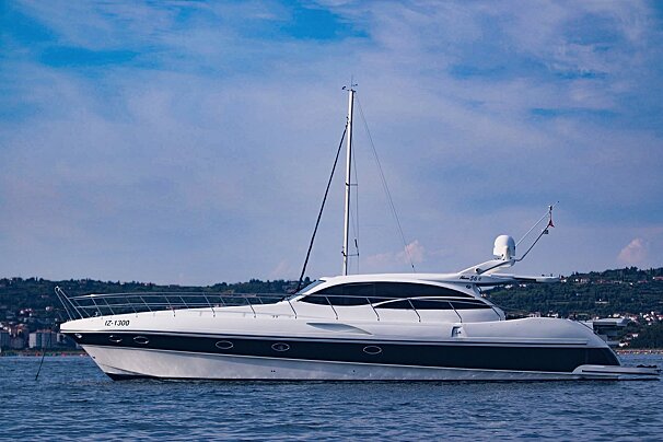 A large, sleek white and dark blue yacht, marked 