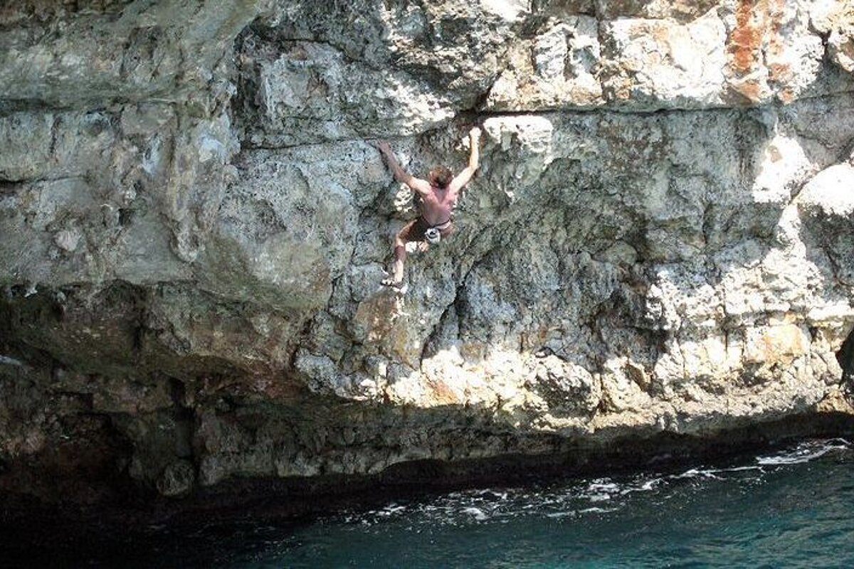 a man deep water soloing in Mallorca