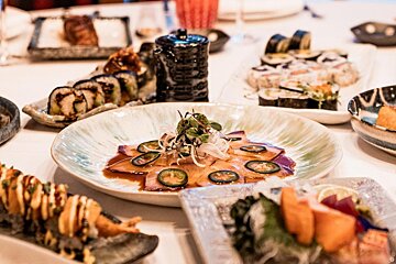A plate of food with jalapenos on it sits on a table