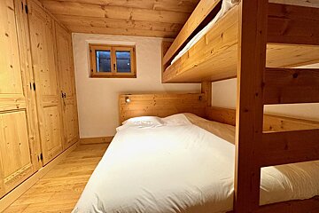 A bedroom with bunk beds and a window