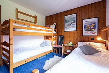 A bedroom with bunk beds and a framed poster that says