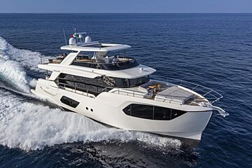 A large white yacht is floating in the ocean