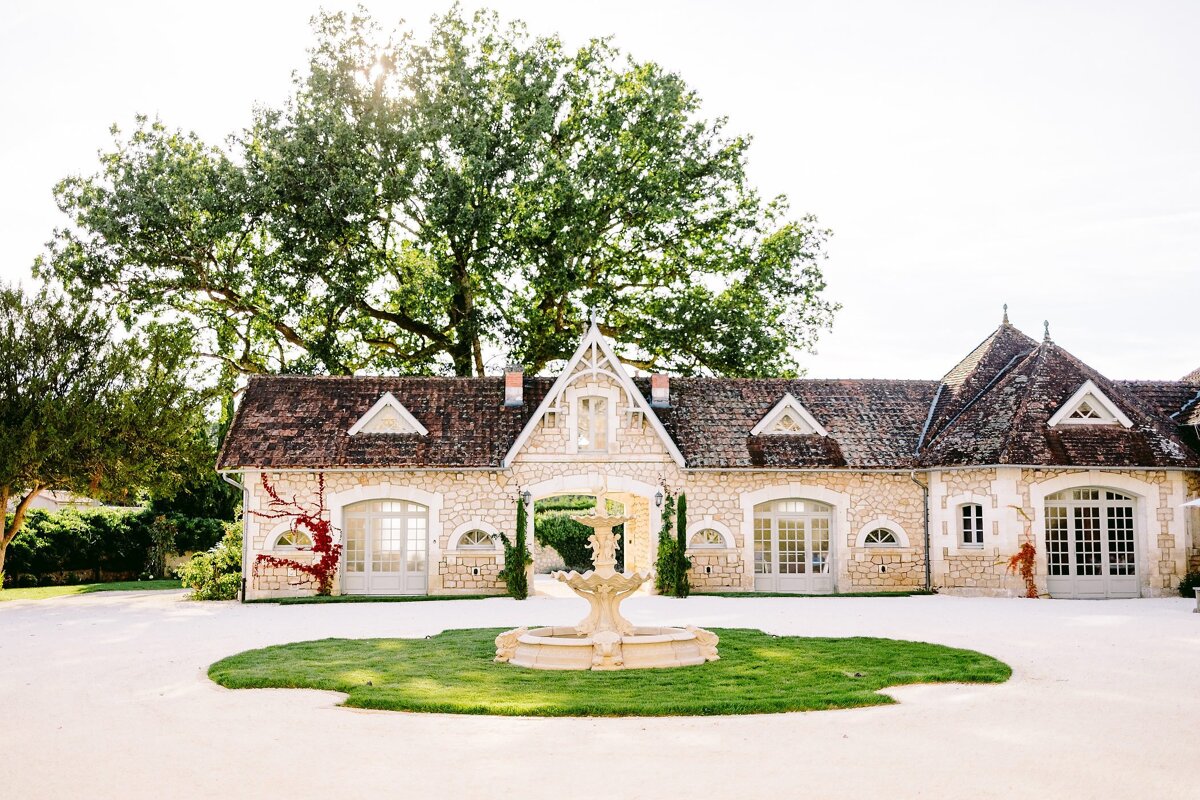 A stone building with a fountain in front of it