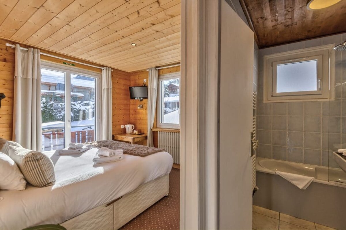 A bedroom with a king size bed and a bathroom