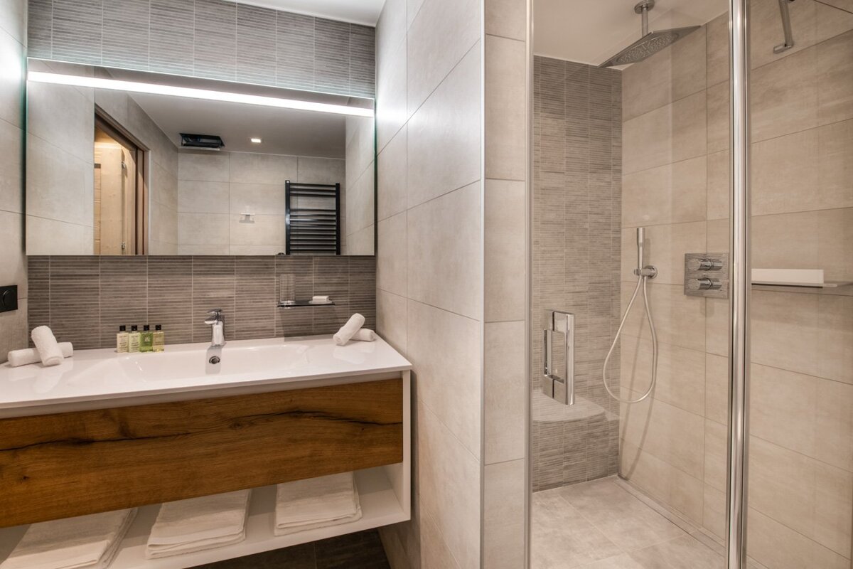 A bathroom with a sink and a walk in shower