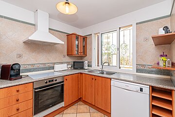 A kitchen with wooden cabinets and a bosch dishwasher