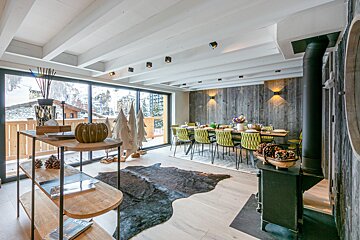 A living room with a dining table and chairs