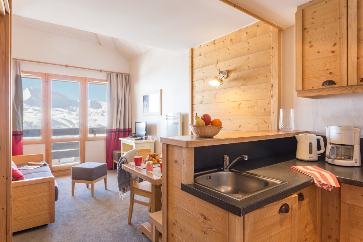 A kitchen with a sink and a coffee maker