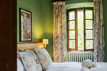 A bedroom with a poster on the wall that says route des alpes