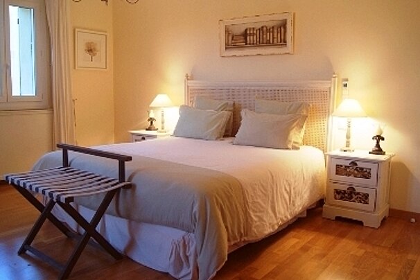 A bedroom with a large bed and two nightstands