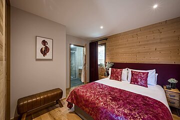 A bedroom with a bed and a picture on the wall