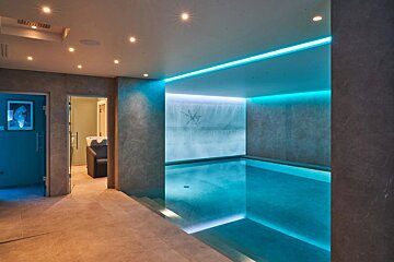 A swimming pool in a room with a x on the wall