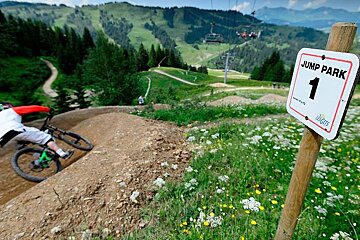 a mountain biker taking a corner in les gets