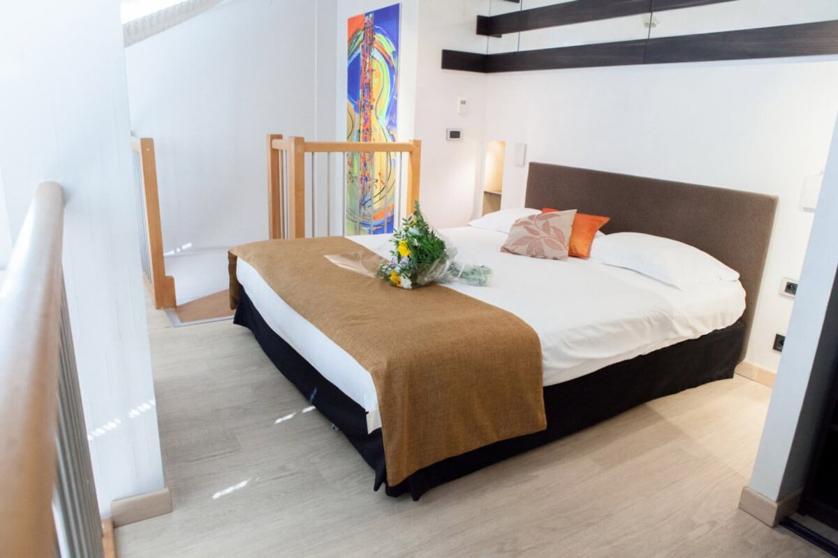 A bed with a bouquet of flowers on it