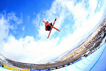 a skier in the air with crossed skis