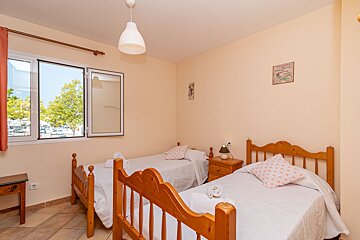A bedroom with two beds and a picture of a bicycle on the wall
