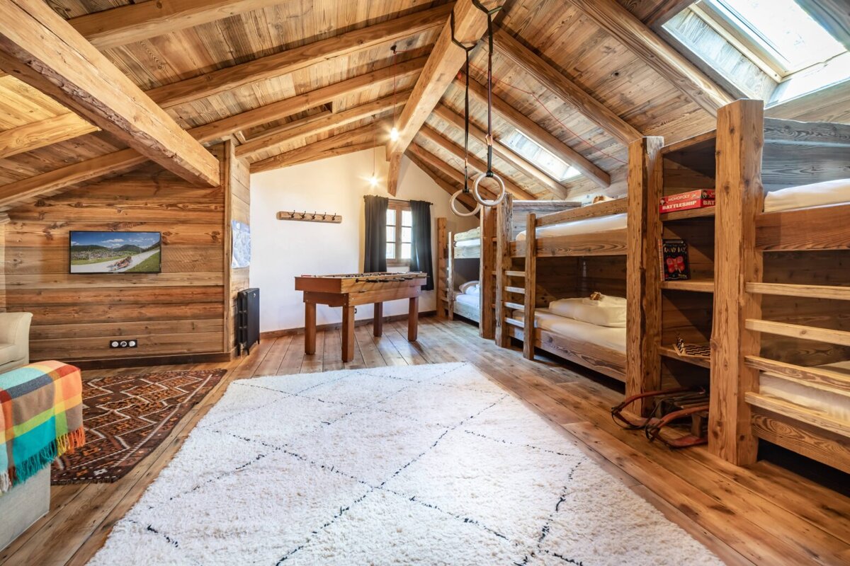A room with bunk beds and a table with a board game on it