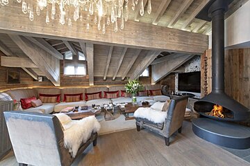 A living room with a fireplace and a large sectional couch