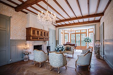 A living room with a fireplace and chandeliers