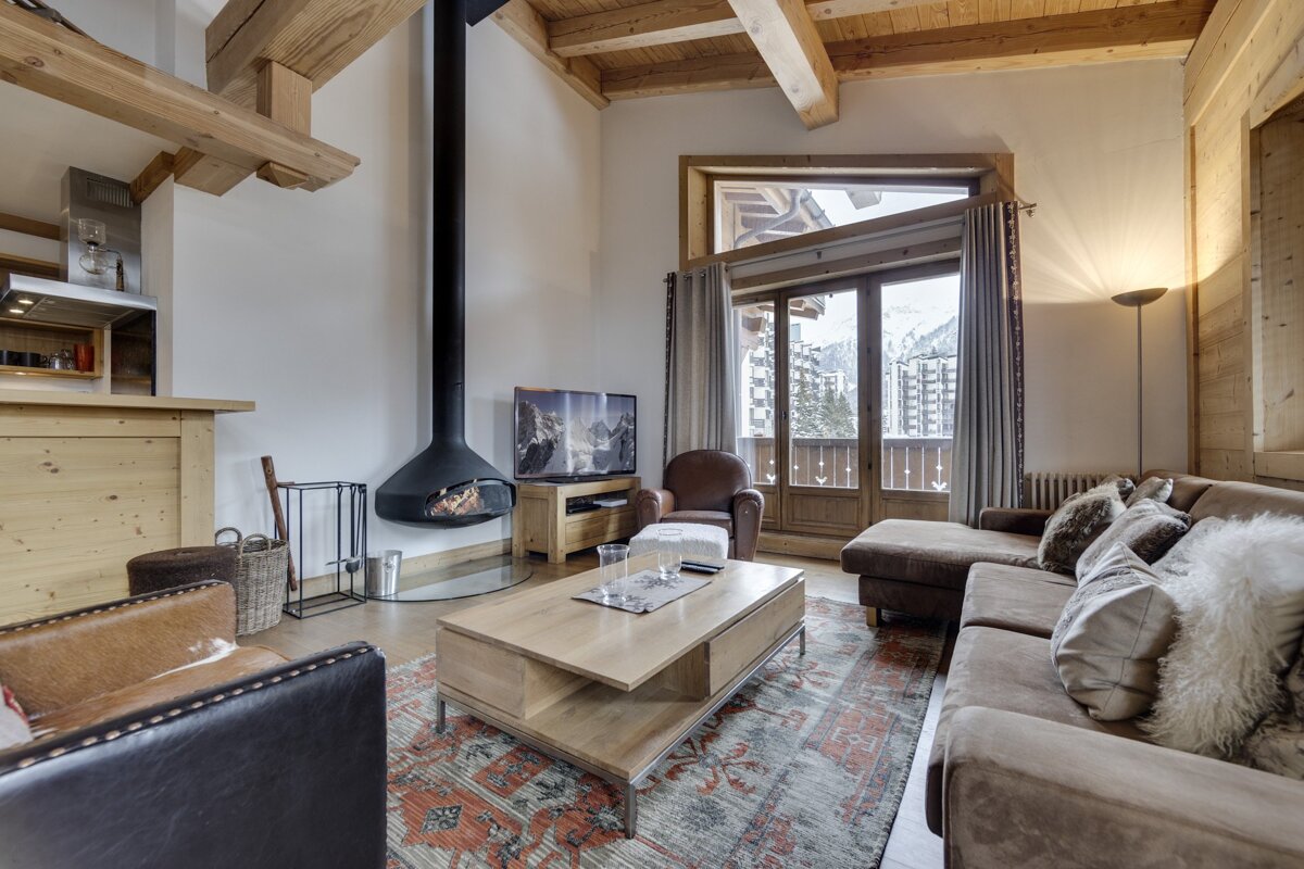 A living room with a couch a chair and a fireplace