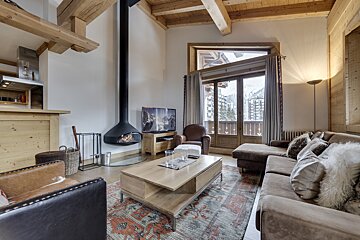 A living room with a couch a chair and a fireplace