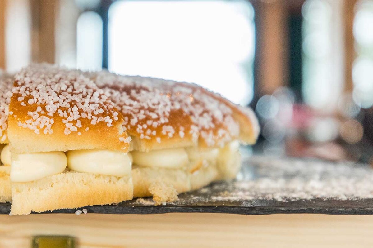 A close up of a sandwich with powdered sugar on top