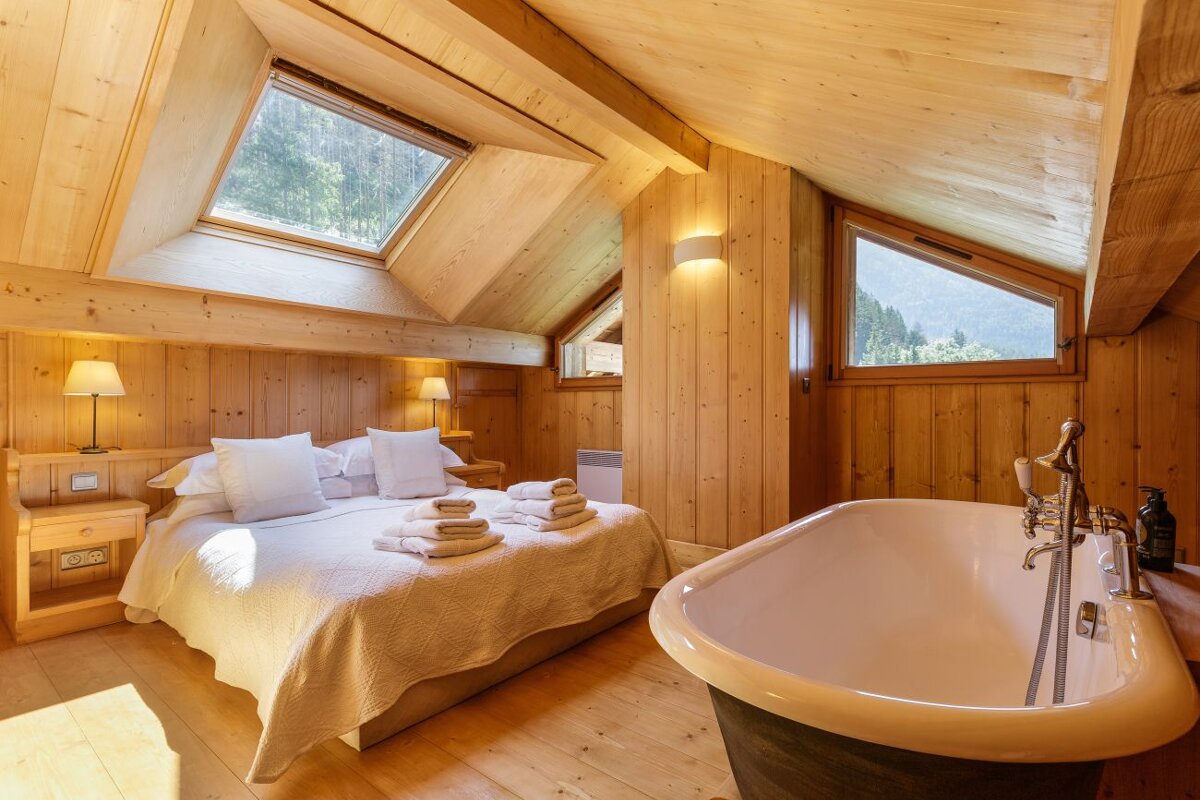 A bedroom with a king size bed and a bathtub