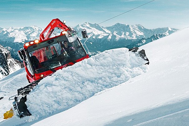 grooming the pistes with a piste basher