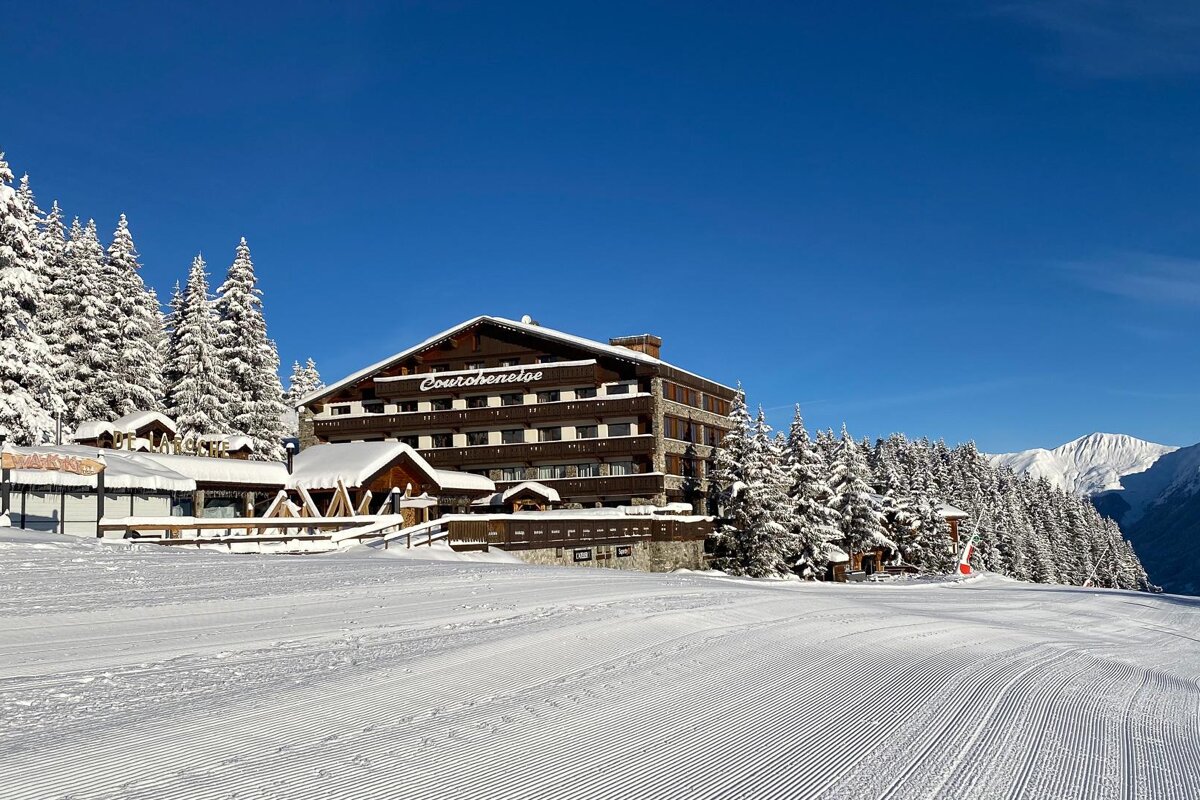 A snowy landscape with a large building that says continental