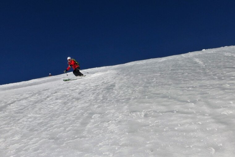 a skier in a red jacket