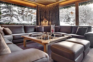 A living room with a large sectional couch and a coffee table