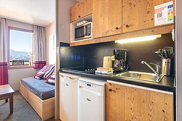 A kitchen with a sticker on the wall that says ' a ' on it