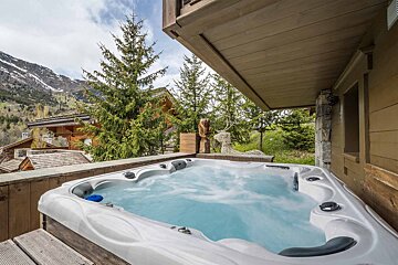A hot tub with a mountain in the background