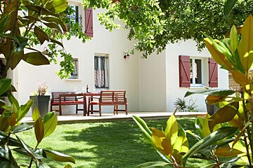 A white house with red shutters on the windows