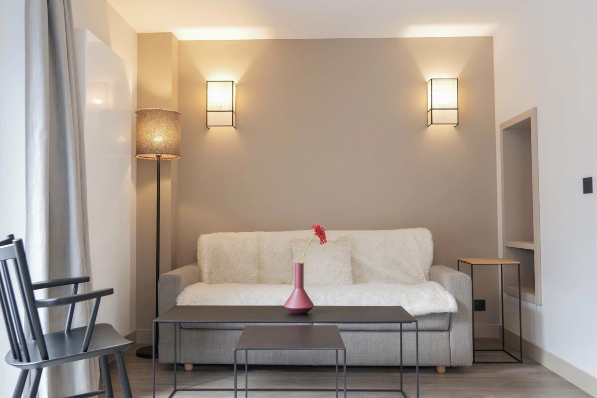 A living room with a couch and two tables