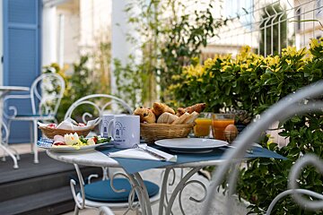 A table with a basket of bread and a mug that says 